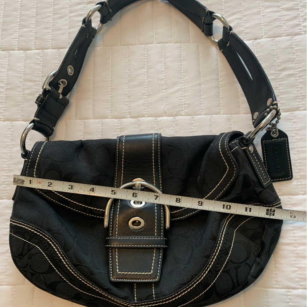 Vintage Coach!  She’s great over the shoulder, tucked under the arm.